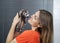 Happy Woman Playing With Weasel In Veterinary