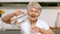 Happy woman pouring glass of water