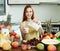 Happy woman pouring milk cocktail with fruits