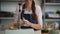 Happy woman pouring paint colors powder on vintage balance in pottery studio - Focus on balance