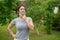 Happy woman pulls down a mask outdoors. A joyful girl walks in the park alone and takes off a medical mask. Social