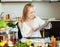 Happy woman putting saltwater fish into sheet pan