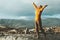 Happy Woman raised hands enjoying landscape