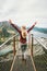 Happy woman raised hands enjoying mountains landscape