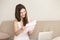 Happy woman reading letter with pleasant news