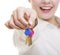 Happy woman real estate agent holding set of keys to new house