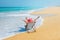 Happy woman in red sunhat on the beach