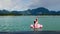 Happy Woman Relax on Vacation, Sitting on Pink Inflatable Flamingo at Blue Lake