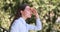 Happy woman relaxes and looks at forest at country house