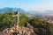 Happy woman remove face mask standing on top mountain breath of fresh air.