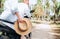 Happy woman riding motorbike with her boyfriend during their tropical vacation under palm trees Straw hat close up image