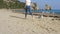 Happy woman running with dog at the beach