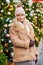 Happy woman in a sheepskin coat and knitted hat