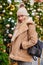 Happy woman in a sheepskin coat and knitted hat