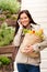 Happy woman shopping vegetables calling cell phone