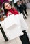 Happy woman shopping with white bags