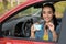 Happy woman showing driving license