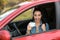 Happy woman showing driving license