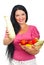 Happy woman showing zucchini