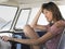 Happy Woman Sitting In Driver\'s Seat Of Campervan