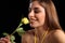 Happy woman smelling single yellow rose flower