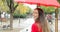 Happy woman smiling looking at camera under the rain