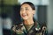 Happy woman soldier with confidence, camouflage and pride, relax outside army building. Professional military career