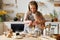 Happy woman and son cooking together in kitchen