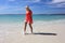 Happy woman splashing feet at the beach