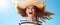 Happy woman in straw hat jumping against blue sky