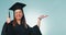 Happy woman, student and palm with thumbs up for graduation success against a studio background. Portrait of female