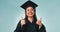 Happy woman, student and thumbs up for graduation, success or thank you against a studio background. Portrait of female