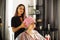 Happy woman with stylist making mask at salon