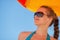 Happy woman in sunglasses on windy beach