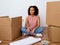 Happy woman surrounded by large boxes