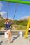 Happy woman on swings on beach