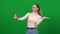 Happy woman taking selfie on green screen. Positive Caucasian lady photographing at chromakey background. Device