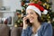 Happy woman talking on phone on christmas at home