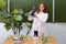 Happy woman teacher with microscope in school class at biology lesson. Scientific research in the educational laboratory of the