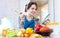 Happy woman tests food with ladle