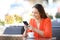 Happy woman is texting on smart phone in a coffee shop