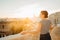 Happy woman tourist enjoying sunset cityscape panorama from Seville`s viewpoint.Amazed visitor having great experience traveling