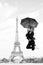 Happy woman travel in paris, france. Woman jump with fashion umbrella. Girl with beauty look at eiffel tower. Parisian