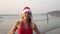 Happy woman on a tropical beach celebrates Christmas or New Year