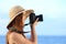 Happy woman on vacation photographing with a dslr camera