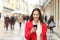 Happy woman walking using a cellphone in the street