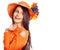 Happy woman wearing orange hat with flower.