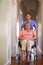 Happy woman, wheelchair and nurse with homecare helping, healthcare service and disability support. Caregiver, disabled