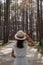 Happy woman in white dress and hat traveling in pine tree forest, tourist visit at Doi Bo Luang, Chiang Mai, Thailand, Landmark