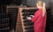 Happy woman winery employee working in cellar